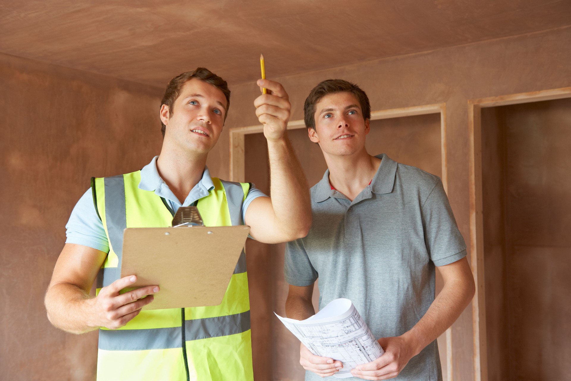 Builder And Inspector Looking At New Property